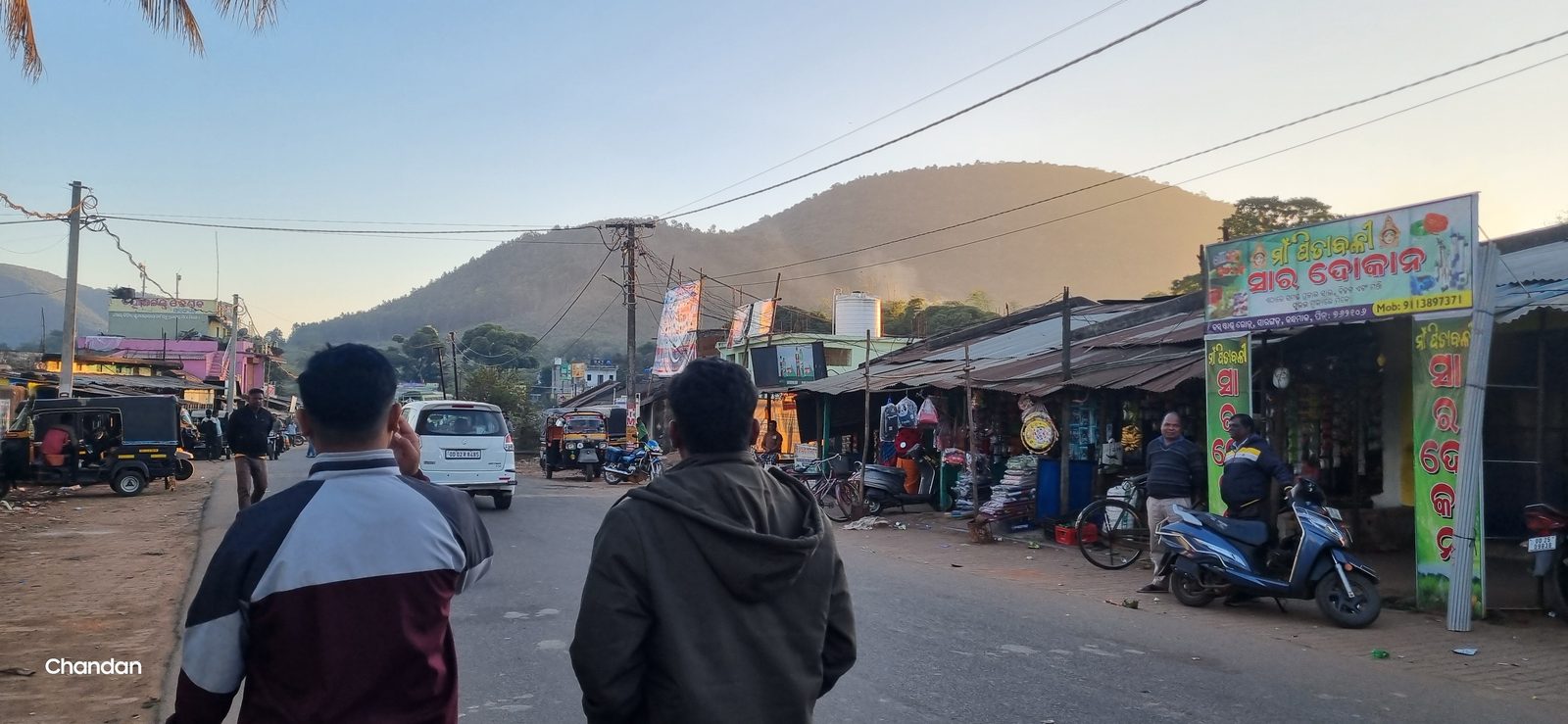 The market road with hills rising behind the shopfronts