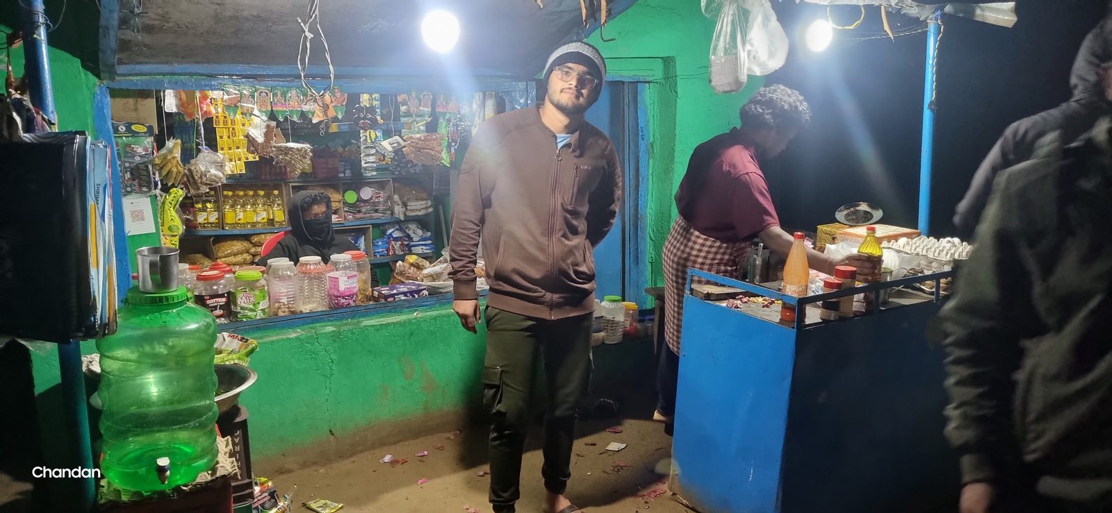 A lit village shop open after dark